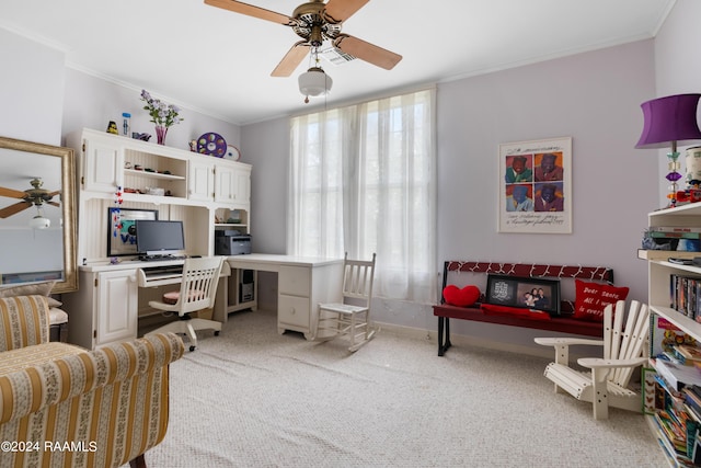 carpeted home office with baseboards, ceiling fan, crown molding, and plenty of natural light