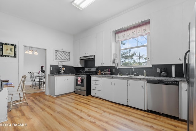 kitchen featuring white cabinetry, stainless steel appliances, under cabinet range hood, a sink, and light wood-style floors