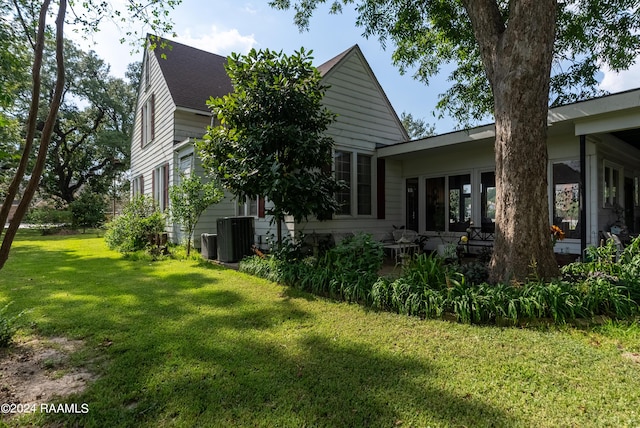 view of home's exterior with a patio and a lawn