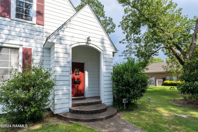 entrance to property with a yard