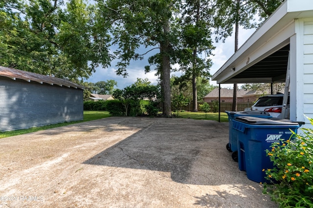 exterior space featuring driveway and fence