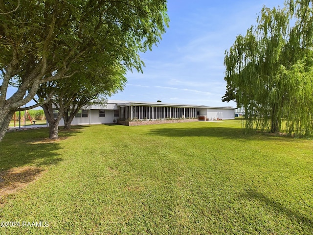 view of yard featuring a sunroom