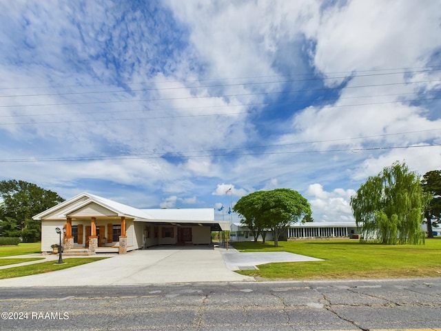 single story home featuring an attached carport, concrete driveway, and a front yard