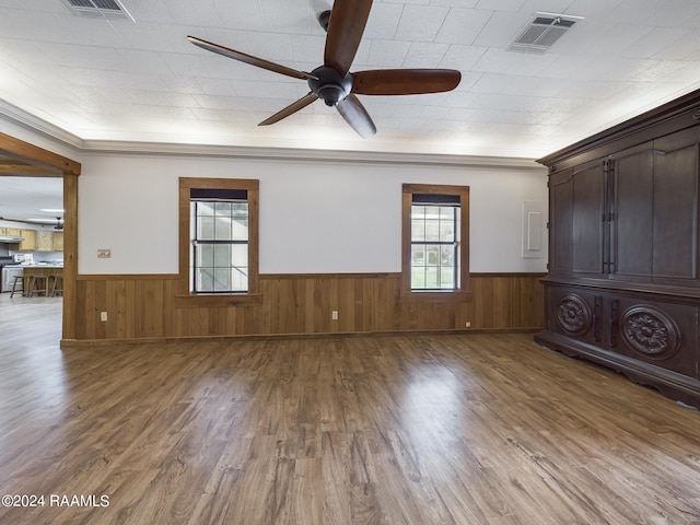 unfurnished room featuring wainscoting, visible vents, ceiling fan, and wood finished floors