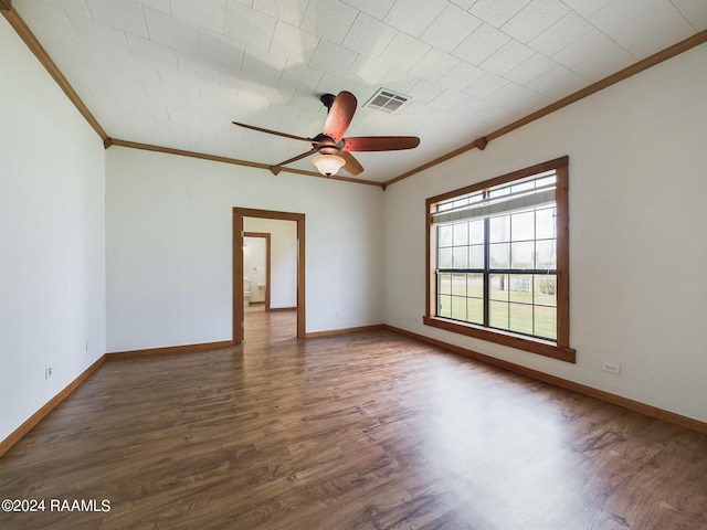 unfurnished room with ornamental molding, visible vents, baseboards, and wood finished floors