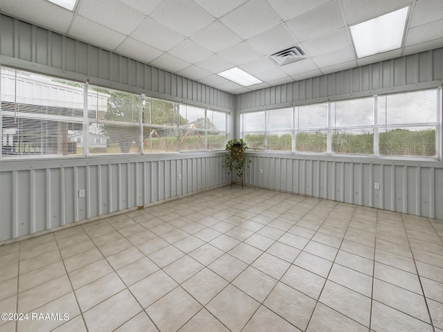 unfurnished sunroom with a paneled ceiling and visible vents