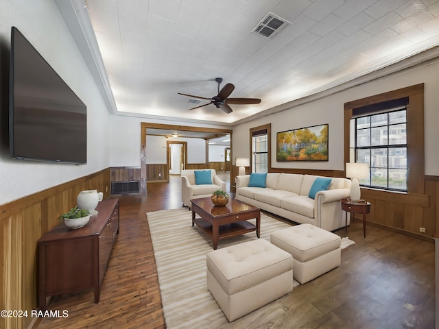 living room featuring ceiling fan, visible vents, wood finished floors, and wainscoting