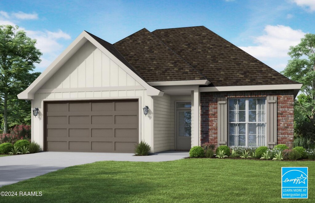 view of front of home featuring a front yard and a garage