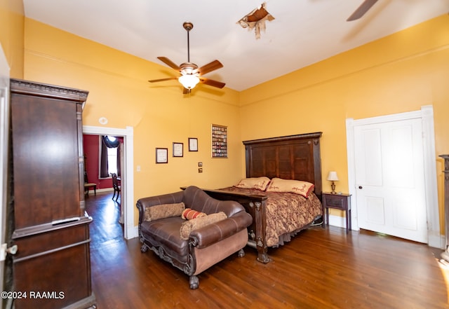 bedroom with dark hardwood / wood-style flooring and ceiling fan