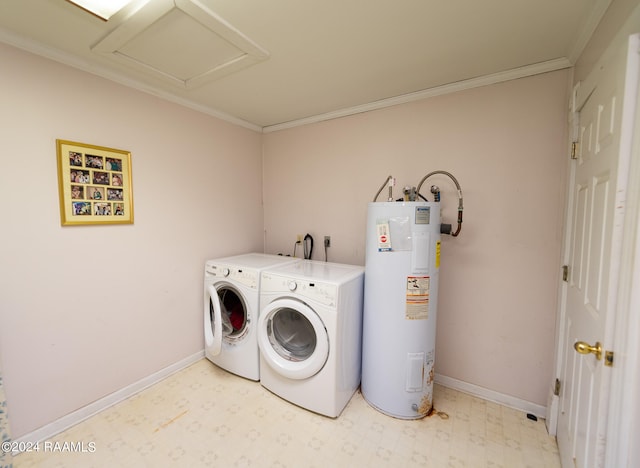 clothes washing area featuring electric water heater, ornamental molding, and separate washer and dryer