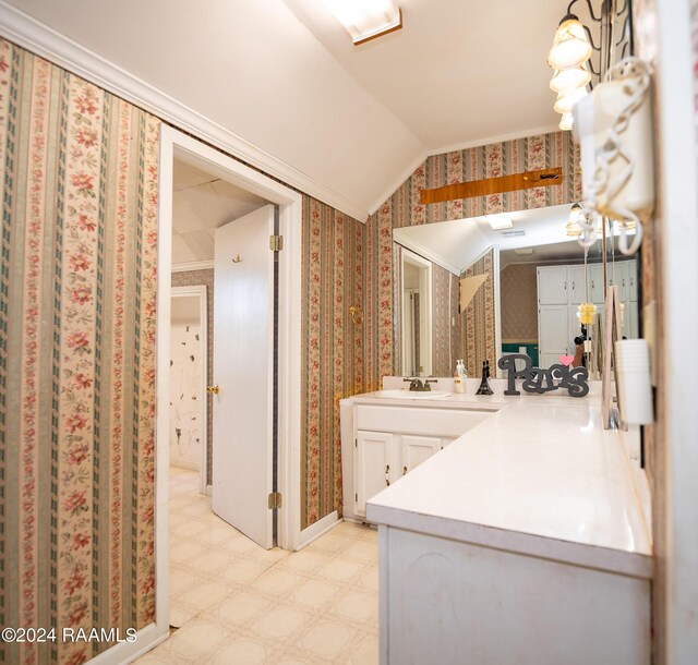 bathroom featuring vaulted ceiling and vanity