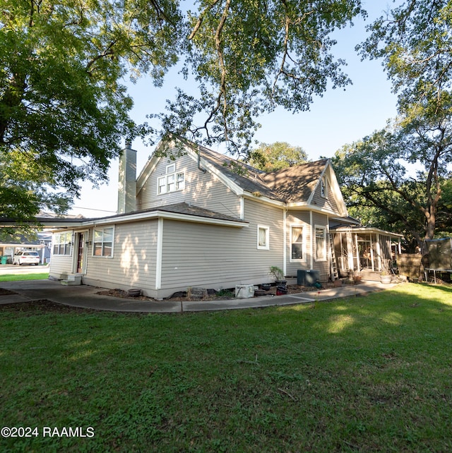 view of side of home with a lawn