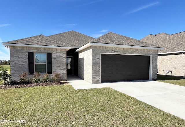 view of front of house featuring a garage and a front lawn