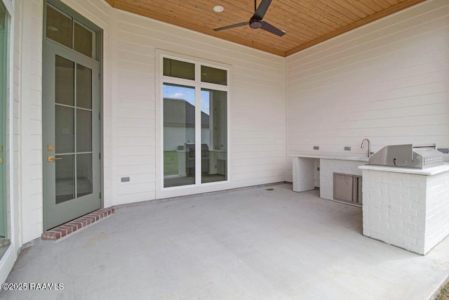 view of patio with a ceiling fan and exterior kitchen