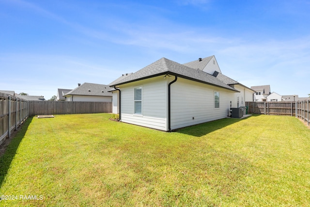 back of property featuring a yard and cooling unit