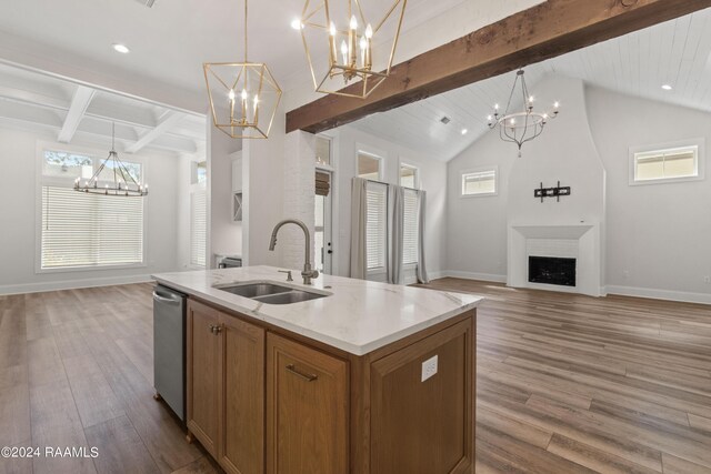 kitchen with a chandelier, lofted ceiling with beams, sink, an island with sink, and hardwood / wood-style flooring