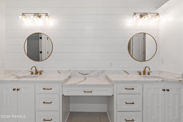 bathroom with tile patterned flooring, vanity, and wooden walls