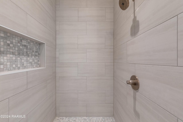 bathroom with tiled shower