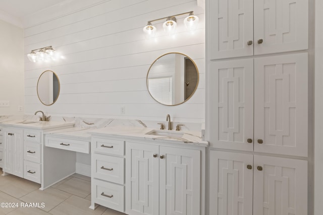 bathroom with wood walls, tile patterned flooring, and vanity