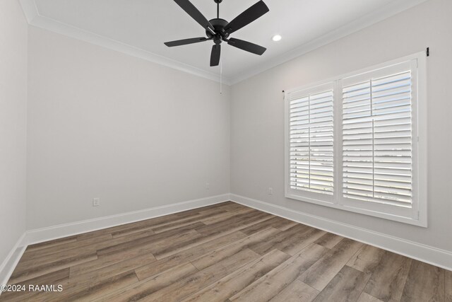 empty room featuring hardwood / wood-style flooring, a healthy amount of sunlight, and ceiling fan