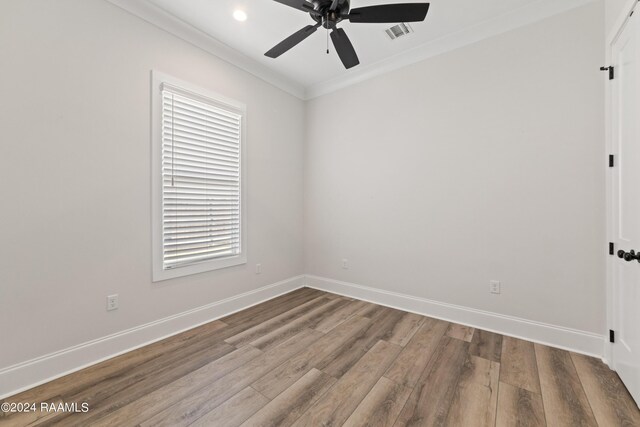 empty room with hardwood / wood-style floors, ceiling fan, and a healthy amount of sunlight