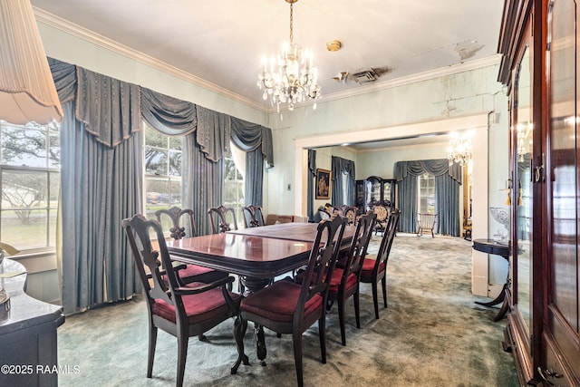 dining area featuring ornamental molding, carpet, and a notable chandelier