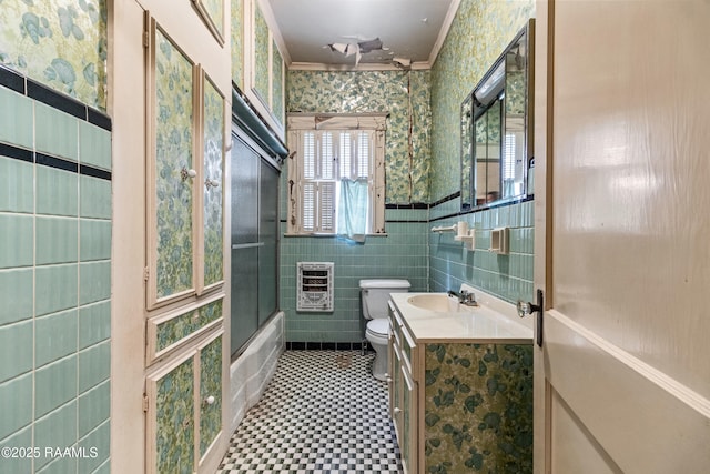 full bathroom with crown molding, tile walls, heating unit, vanity, and toilet