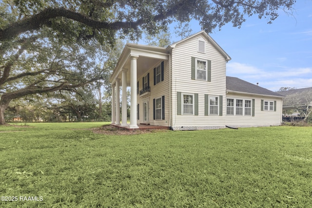 back of house featuring a yard