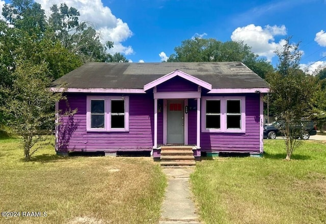 bungalow-style home with a front lawn