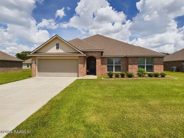 single story home with a garage and a front yard