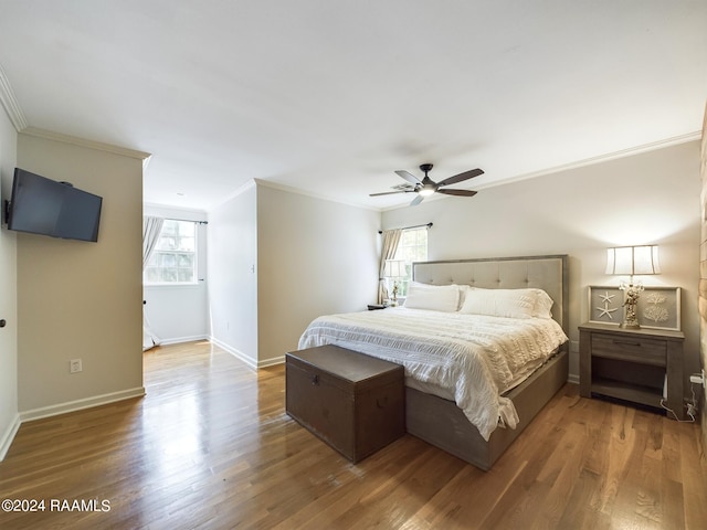 bedroom with crown molding, multiple windows, hardwood / wood-style floors, and ceiling fan