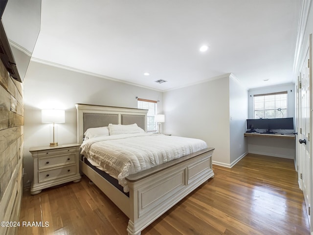 bedroom with ornamental molding and hardwood / wood-style floors