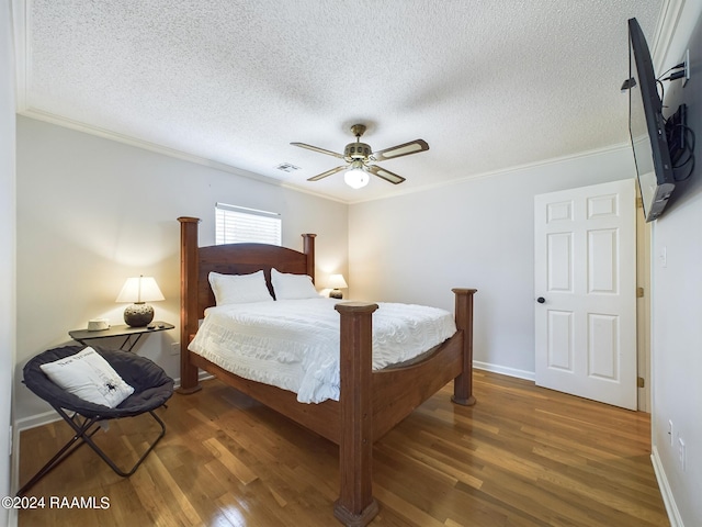 68335 Taulla Dr, Covington, LA 70433 - bedroom with wood finished floors, crown molding, a textured ceiling, and ceiling fan