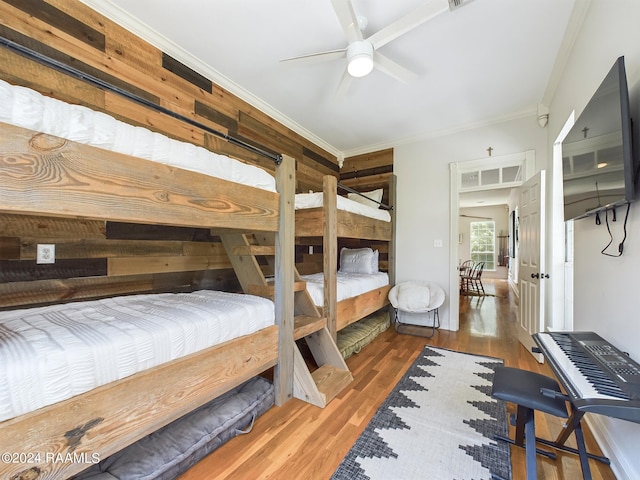 bedroom featuring crown molding, ceiling fan, and hardwood / wood-style floors