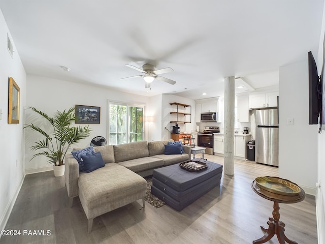 living room featuring ceiling fan and light hardwood / wood-style floors