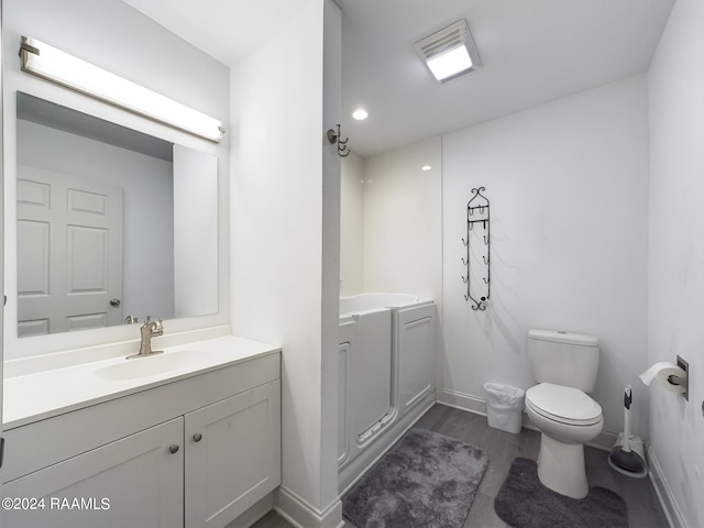 68335 Taulla Dr, Covington, LA 70433 - full bathroom featuring vanity, wood finished floors, and a garden tub