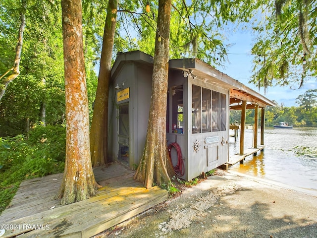 68335 Taulla Dr, Covington, LA 70433 - view of outbuilding with a water view and a sunroom