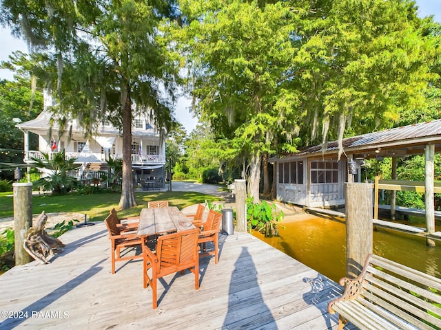 68335 Taulla Dr, Covington, LA 70433 - wooden deck featuring outdoor dining space, a boat dock, and a water view