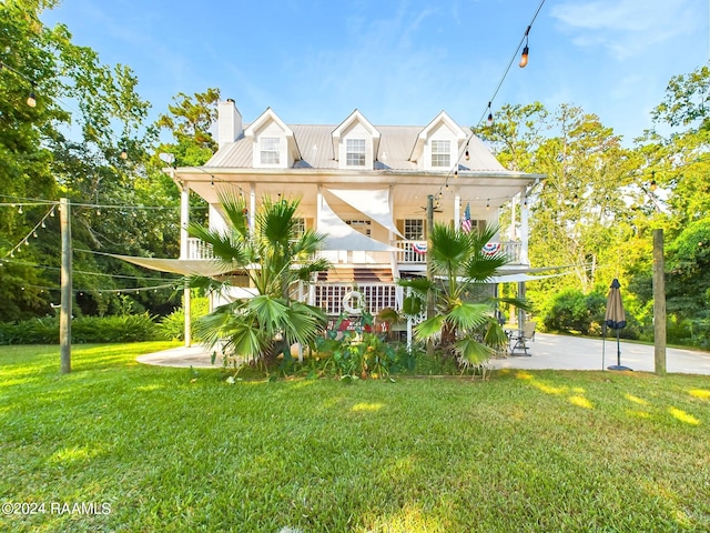 68335 Taulla Dr, Covington, LA 70433 - view of front of home featuring a front lawn, a chimney, a porch, and a patio area