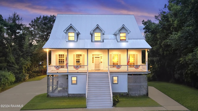 68335 Taulla Dr, Covington, LA 70433 - view of front facade featuring stairs, covered porch, a front lawn, and a metal roof