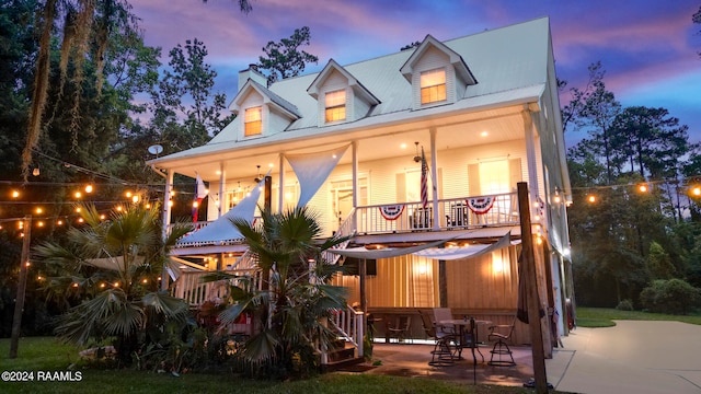 back house at dusk with a porch