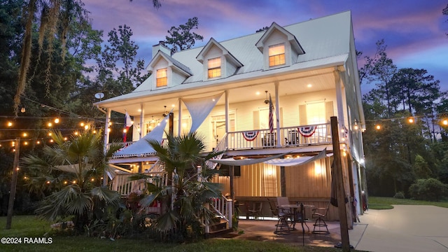 68335 Taulla Dr, Covington, LA 70433 - back of property at dusk with a balcony and a patio