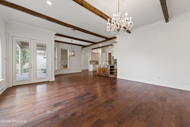 unfurnished living room featuring beamed ceiling, dark wood-style floors, french doors, an inviting chandelier, and baseboards