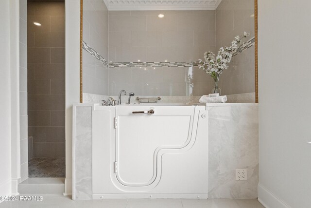 bathroom with tile patterned flooring and tiled shower