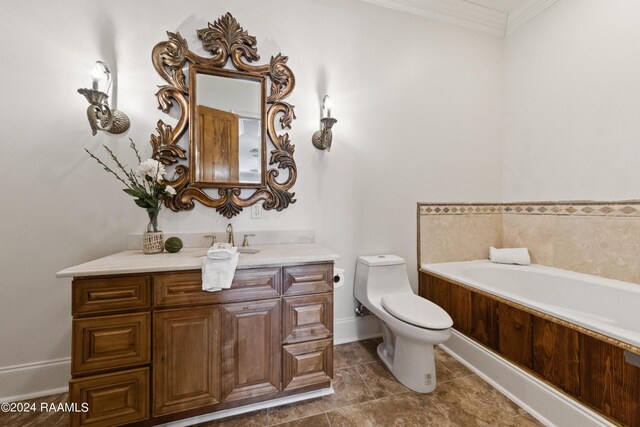 bathroom featuring ornamental molding, vanity, toilet, and a washtub