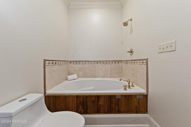 bathroom with crown molding, toilet, and a bathing tub