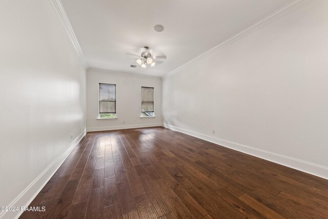 empty room with dark wood-type flooring, ceiling fan, and crown molding