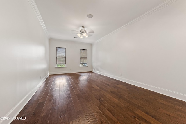 spare room featuring ceiling fan, dark wood-style floors, baseboards, and ornamental molding