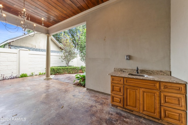 view of patio featuring a sink and fence