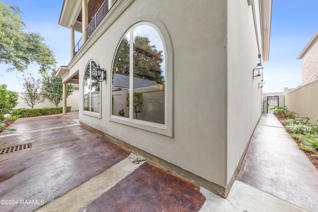 view of home's exterior featuring stucco siding, a patio, and fence